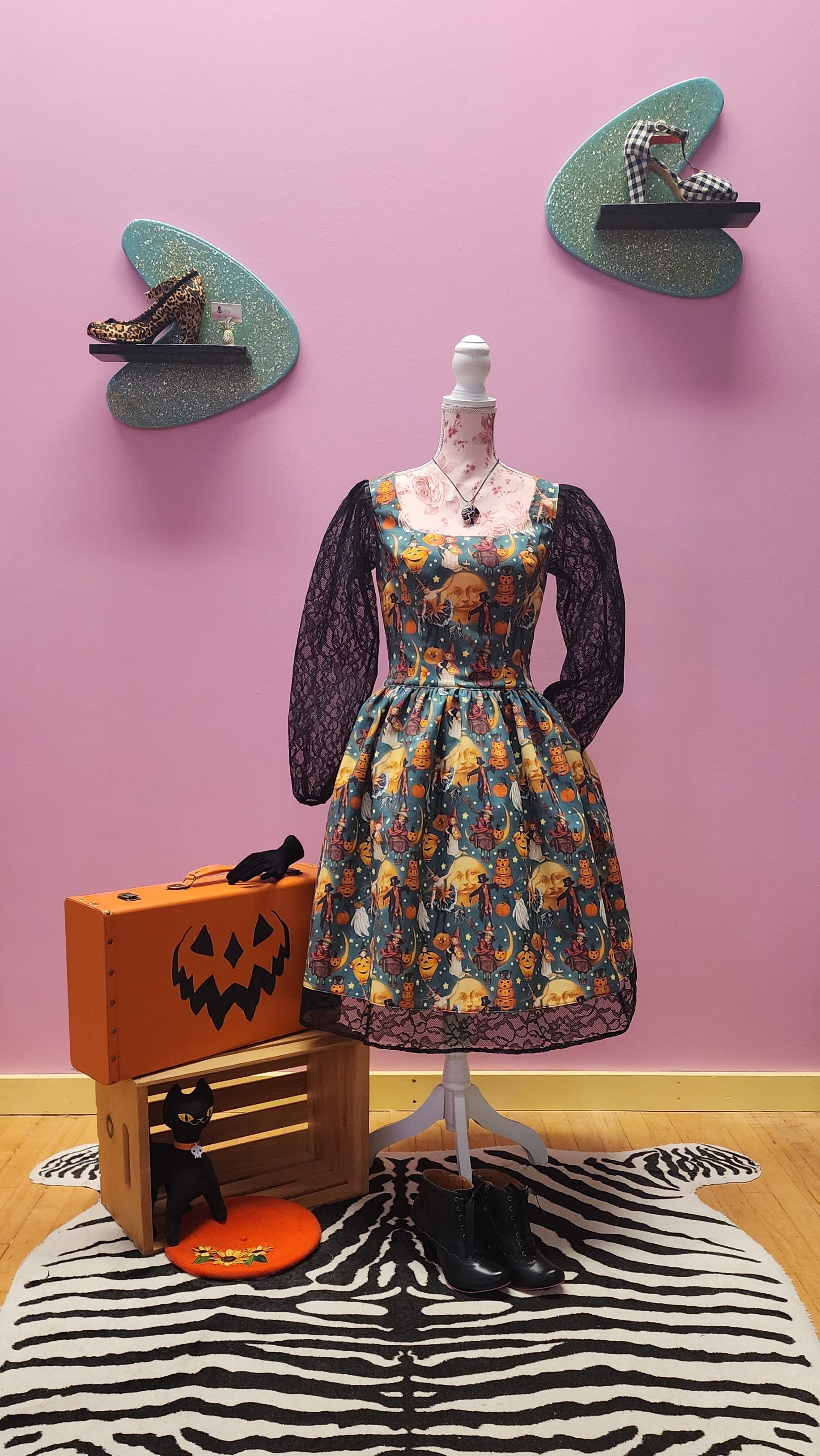 This vintage inspired Halloween print dress features black illusion puff sleeves and hem.