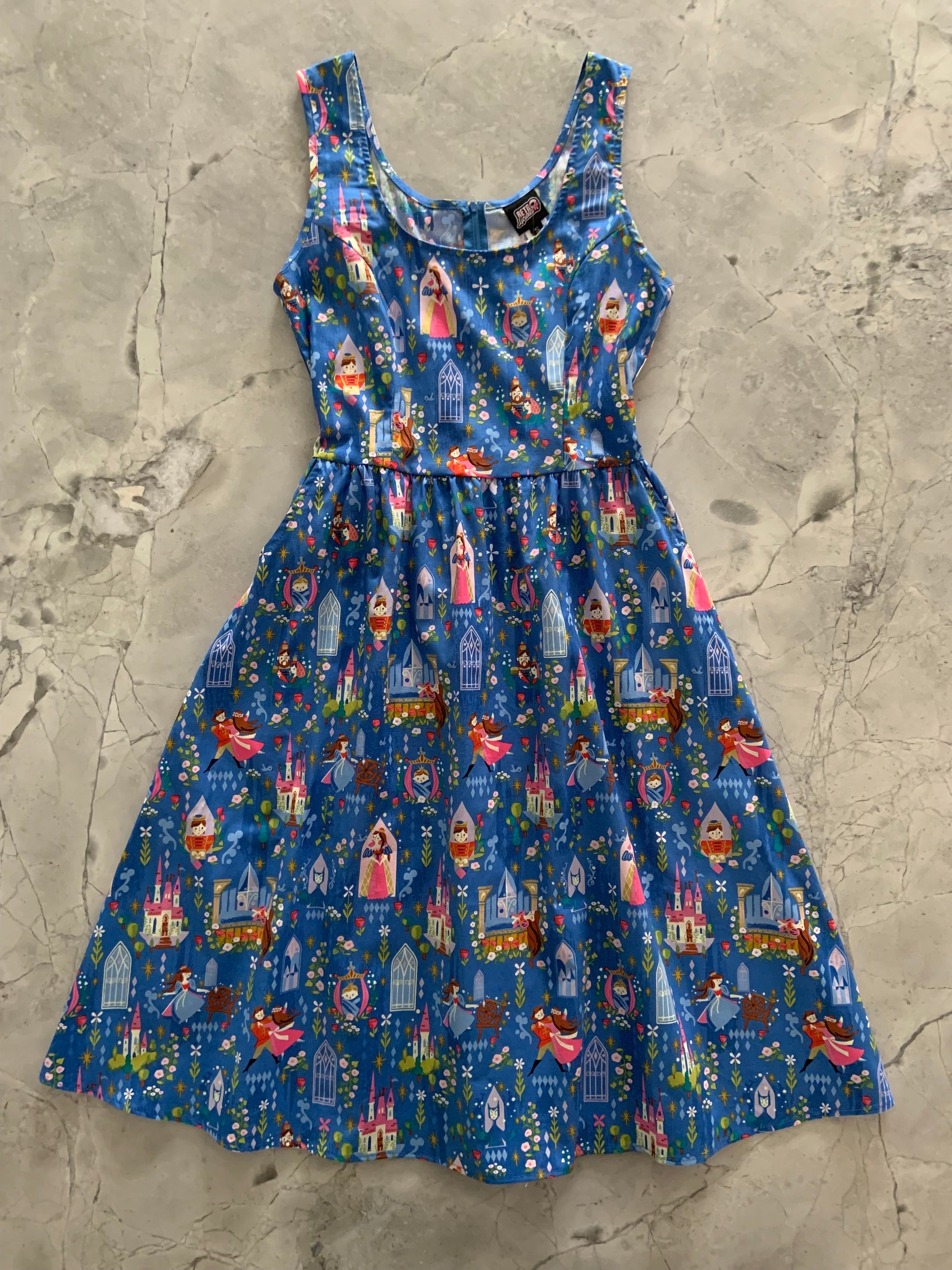 Blue dress with colorful Sleeping Beauty pattern print.