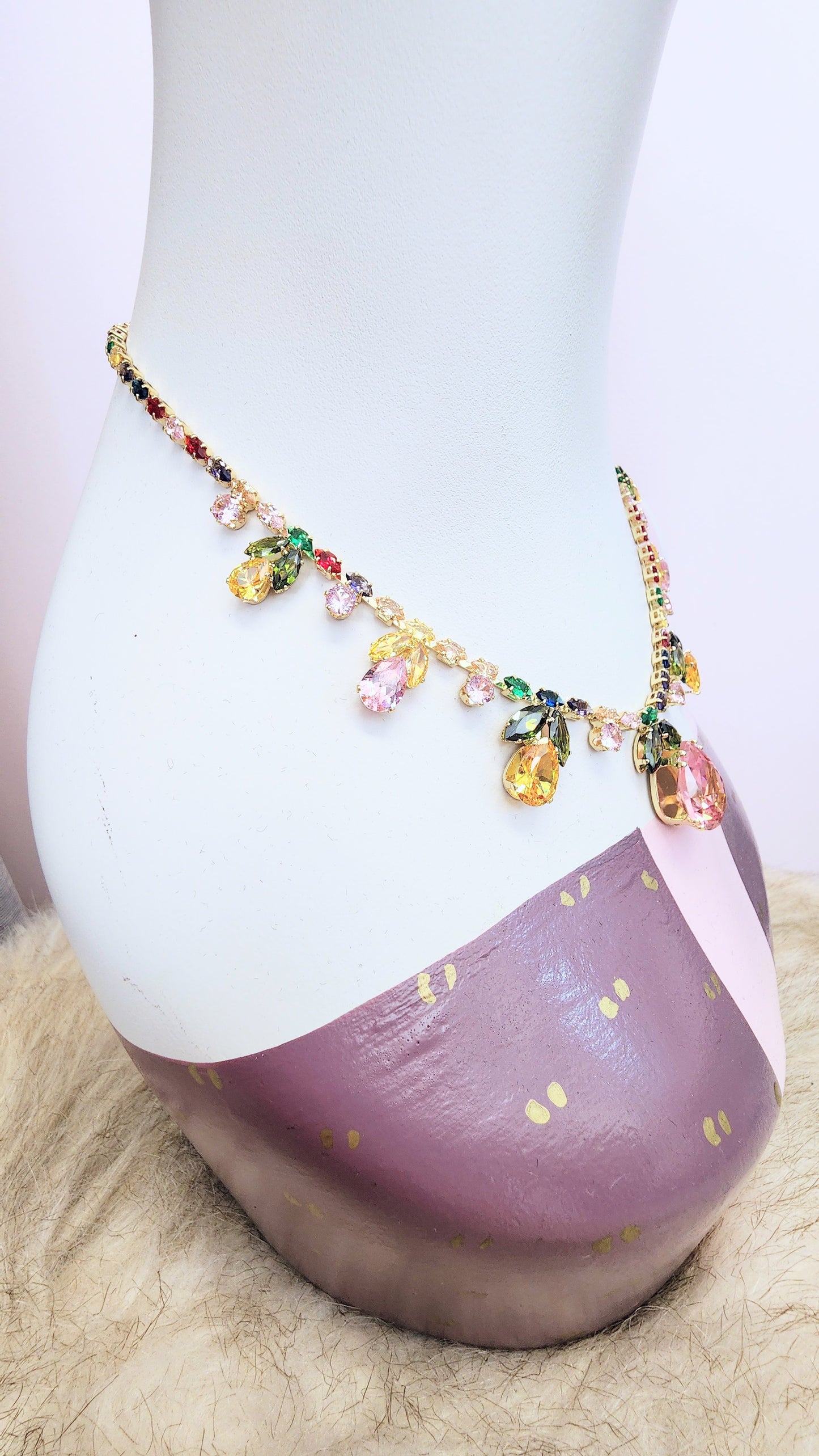 Necklace with colorful floral pastel rhinestones on a mannequin bust against a light background at Hollyville pinup boutique in South Milwaukee